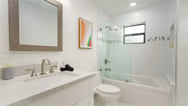 a bedroom with a bed a flat screen tv and a window