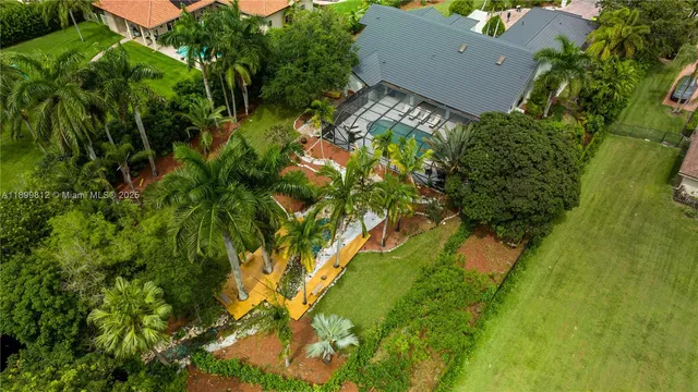 an aerial view of a house with a yard