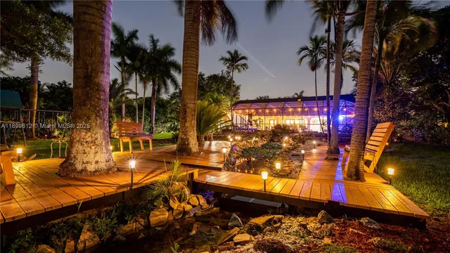 an aerial view of a house with swimming pool and garden