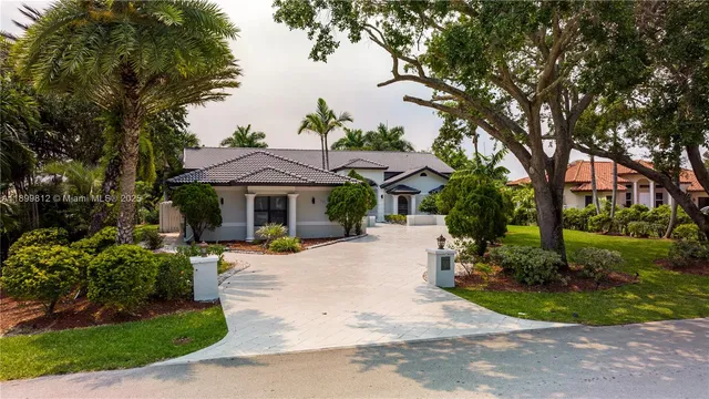 an aerial view of a house with a yard basket ball court and outdoor seating