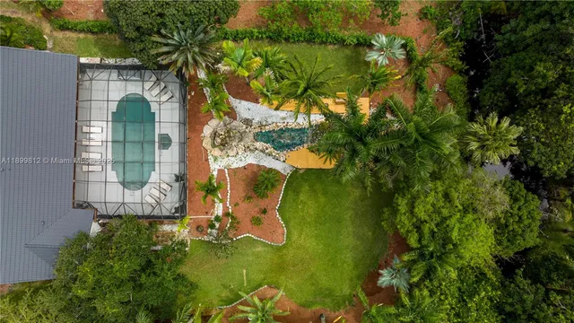 an aerial view of a house with a yard and garden