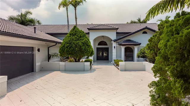 an aerial view of a house with a yard and potted plants