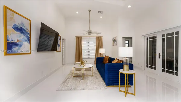 a living room with furniture kitchen view and a large window