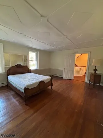 a bedroom with a bed and a chair
