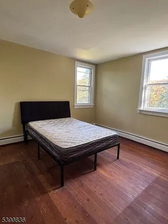 a room with pool table and wooden floor