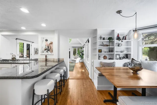a dining room with furniture and wooden floor