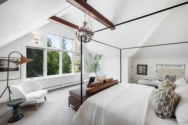 a bedroom with a bed a large window mirror and a balcony