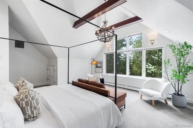 a bedroom with a bed couch and window