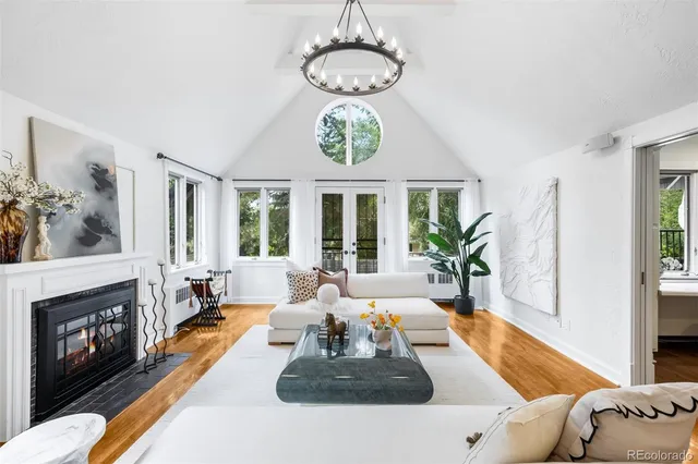 a living room with fireplace furniture and a large window