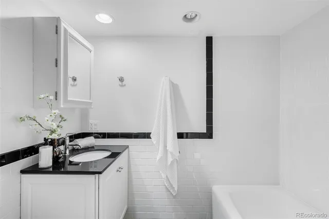 a kitchen with kitchen island a sink appliances and cabinets