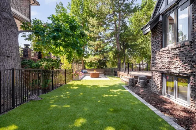 a backyard of a house with table and chairs
