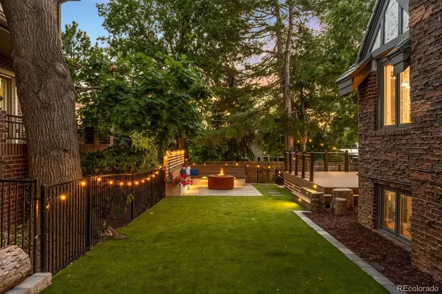 a view of a patio with couple of chairs and potted plants