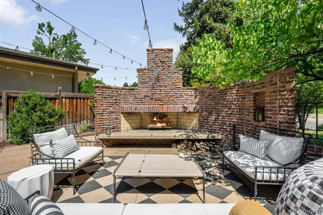 a outdoor space with patio furniture and a fireplace