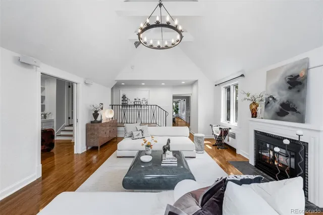 a living room with furniture fireplace and a window