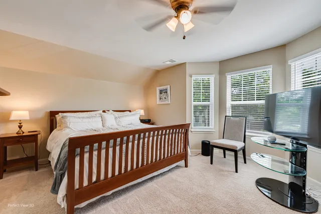 a bedroom with furniture and a flat screen tv
