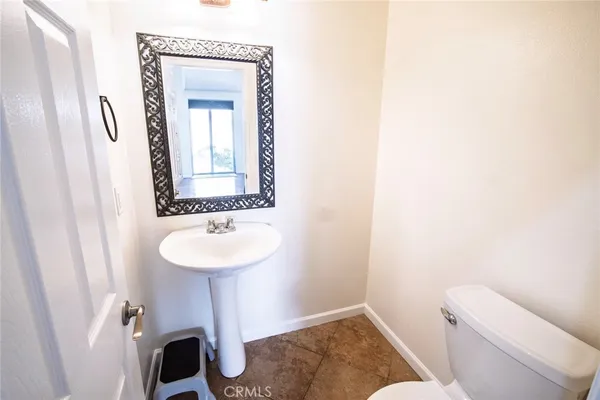 a bathroom with a toilet a sink and a mirror