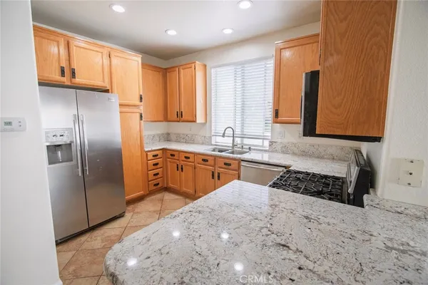 a kitchen with stainless steel appliances a refrigerator sink and cabinets