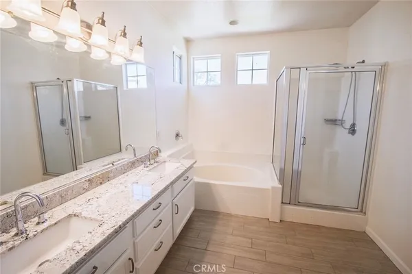 a spacious bathroom with a tub sink and a mirror