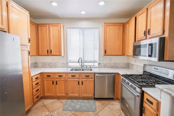 a kitchen with a stove sink and cabinets