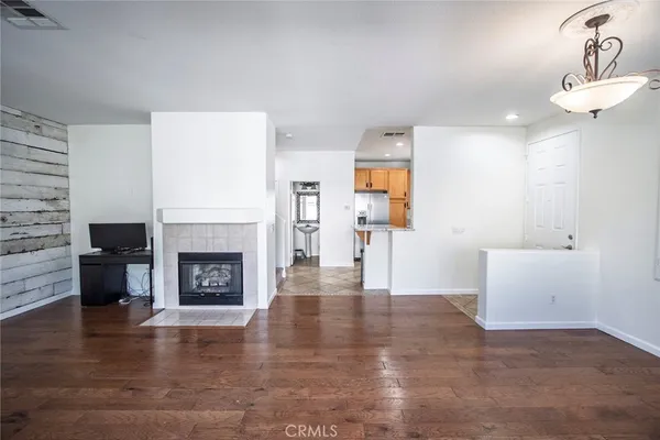 a view of a livingroom with a fireplace and window