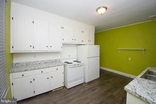 a kitchen with a sink a stove and cabinets