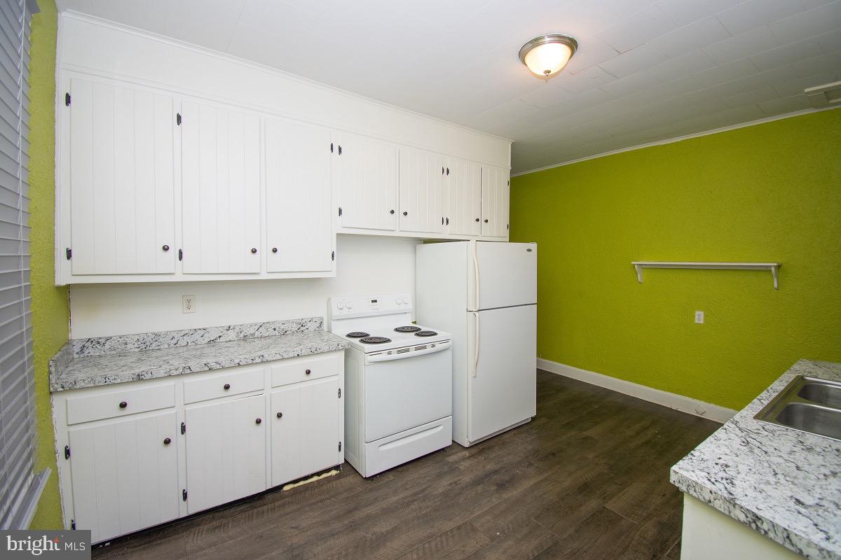 219 West Howard Street Hagerstown, MD 21740 - Photo 1 of 11 a kitchen with a sink a stove and cabinets