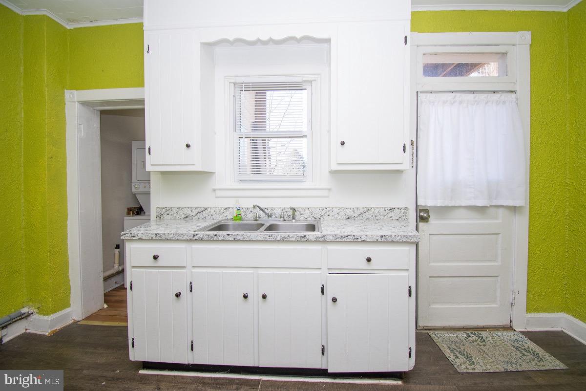 219 West Howard Street Hagerstown, MD 21740 - Photo 2 of 11 a bathroom with a granite countertop sink and a mirror