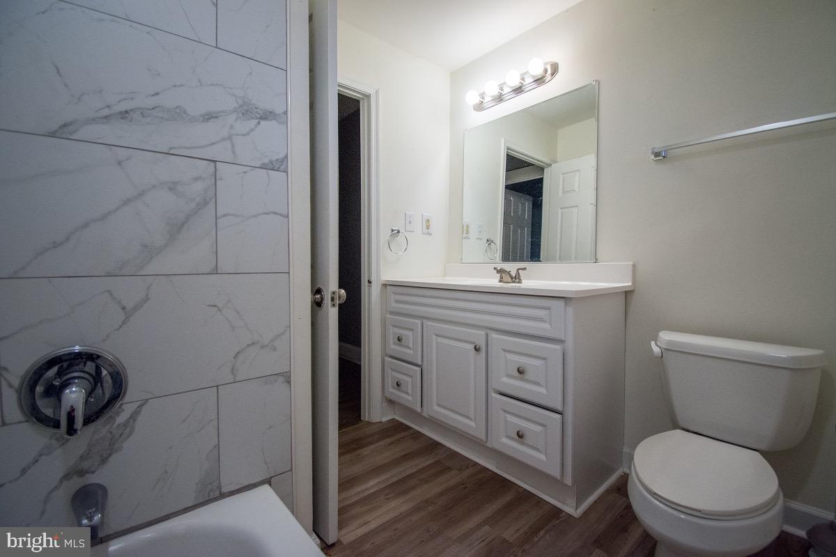 219 West Howard Street Hagerstown, MD 21740 - Photo 5 of 11 a bathroom with a toilet a sink and mirror