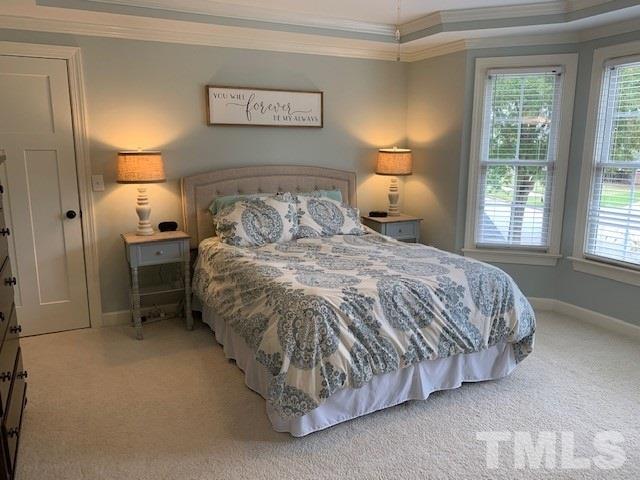 606 Scotts Ridge Trail Apex, NC 27502 - Photo 11 of 22 a bed sitting in a bedroom next to a window and lamp