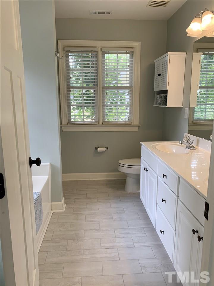 606 Scotts Ridge Trail Apex, NC 27502 - Photo 13 of 22 a bathroom with a sink a toilet and a tub