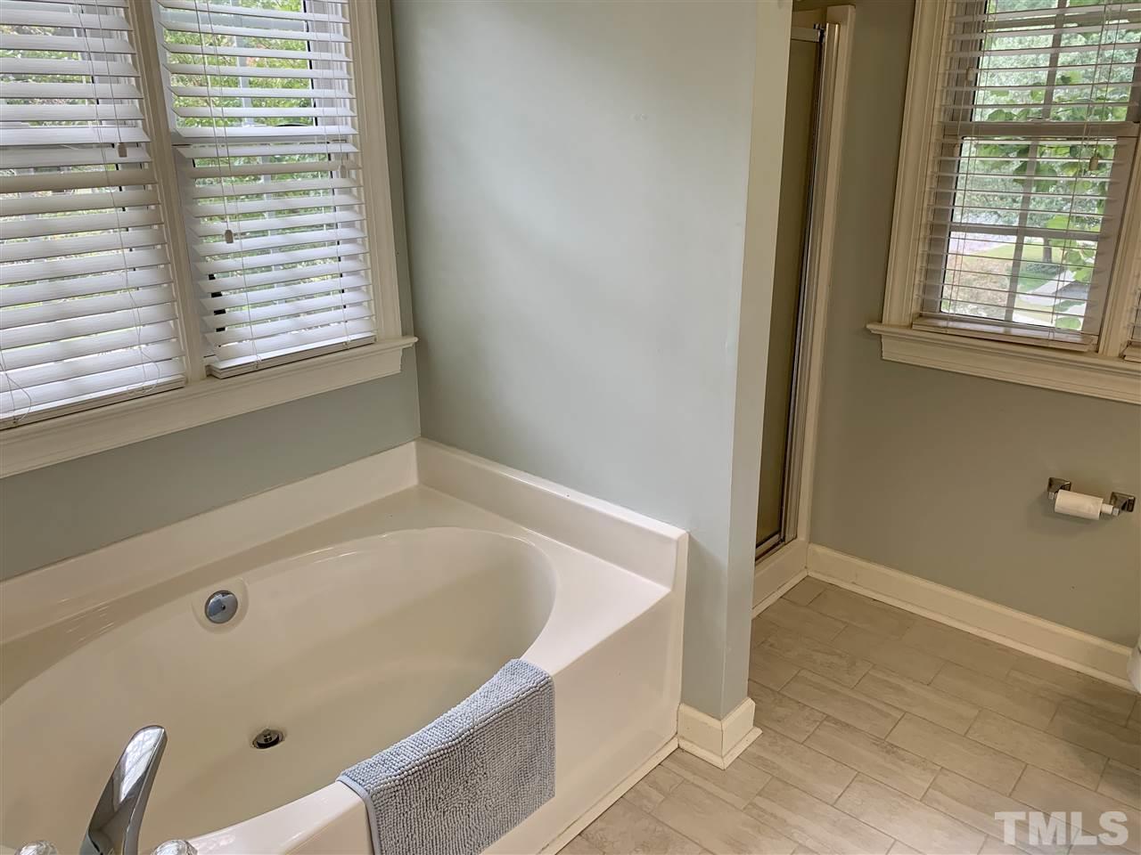 606 Scotts Ridge Trail Apex, NC 27502 - Photo 14 of 22 a bathroom with bathtub and window