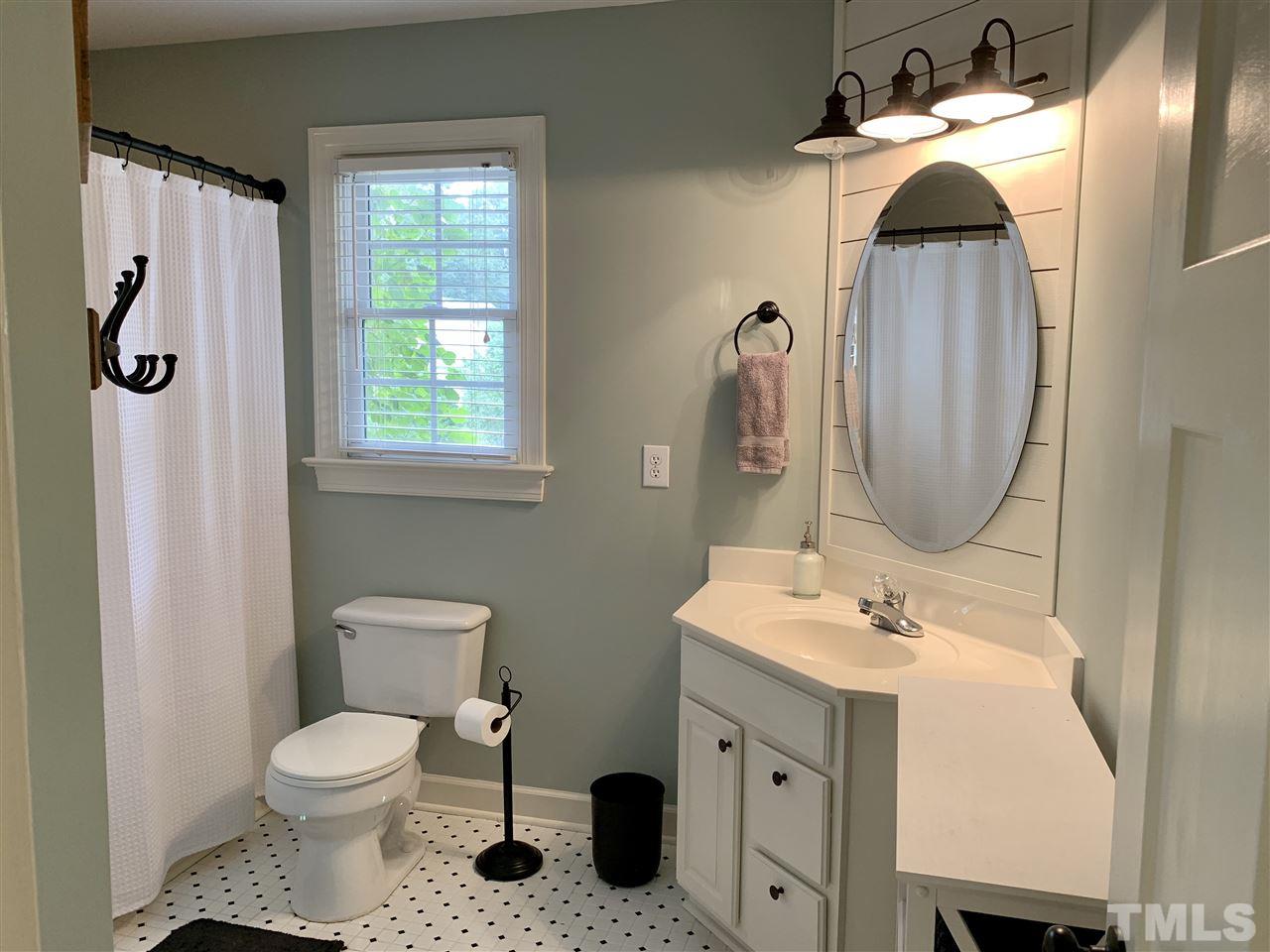 606 Scotts Ridge Trail Apex, NC 27502 - Photo 17 of 22 a bathroom with a toilet sink and mirror