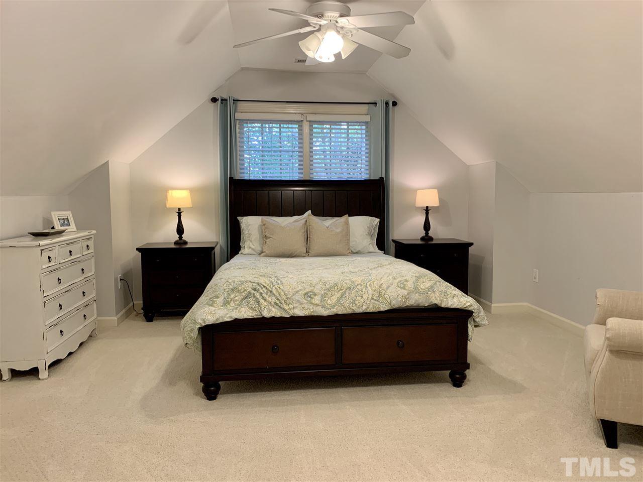 606 Scotts Ridge Trail Apex, NC 27502 - Photo 19 of 22 a bedroom with a bed and a cabinets