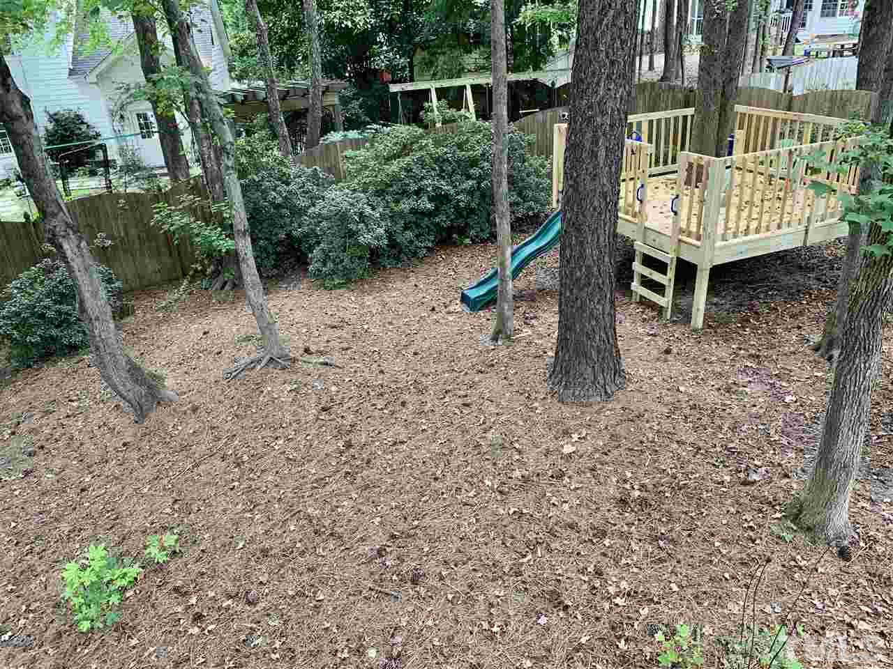 606 Scotts Ridge Trail Apex, NC 27502 - Photo 22 of 22 a backyard of a house with barbeque oven and outdoor seating