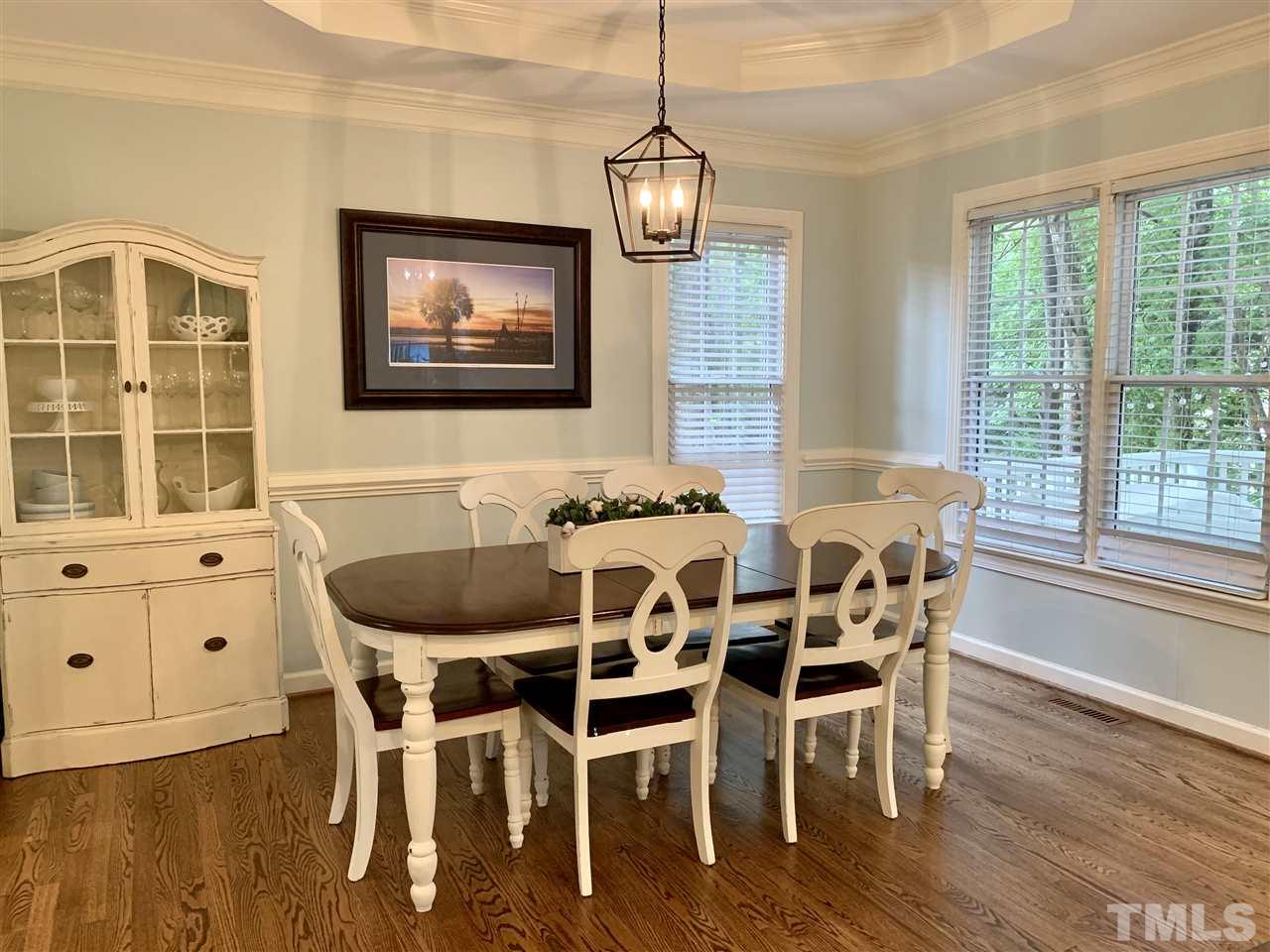 606 Scotts Ridge Trail Apex, NC 27502 - Photo 7 of 22 a dining room with furniture a chandelier and wooden floor