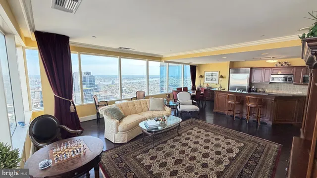 a living room with furniture and a floor to ceiling window