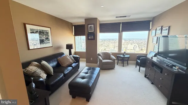 a living room with furniture and a large window