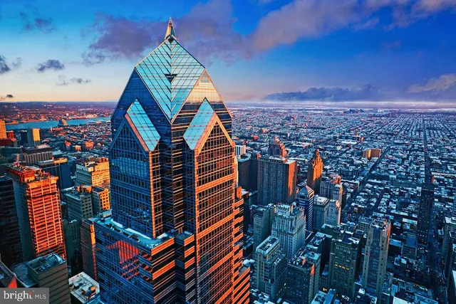 a view of a brick wall with a building in the background