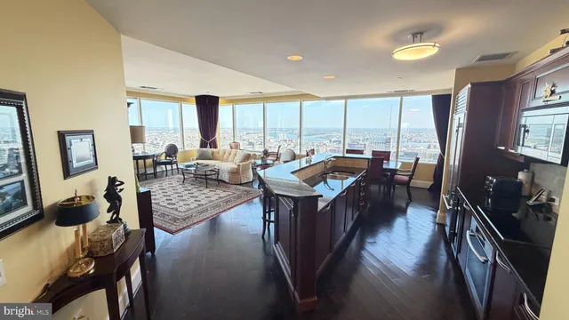 a living room with furniture and large windows