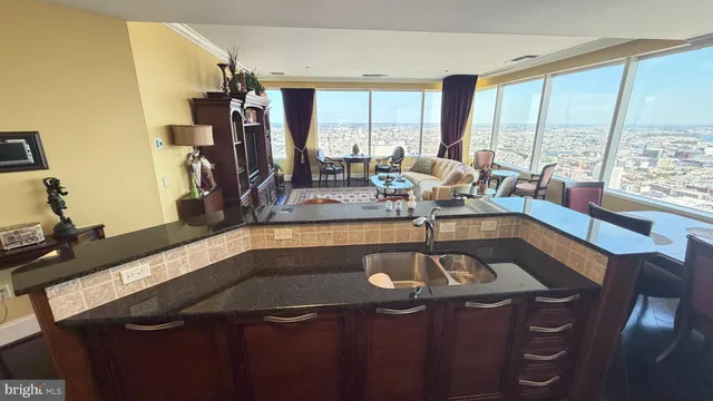 a view of a living room with furniture and floor to ceiling window