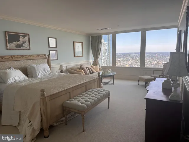 a living room with furniture and a floor to ceiling window