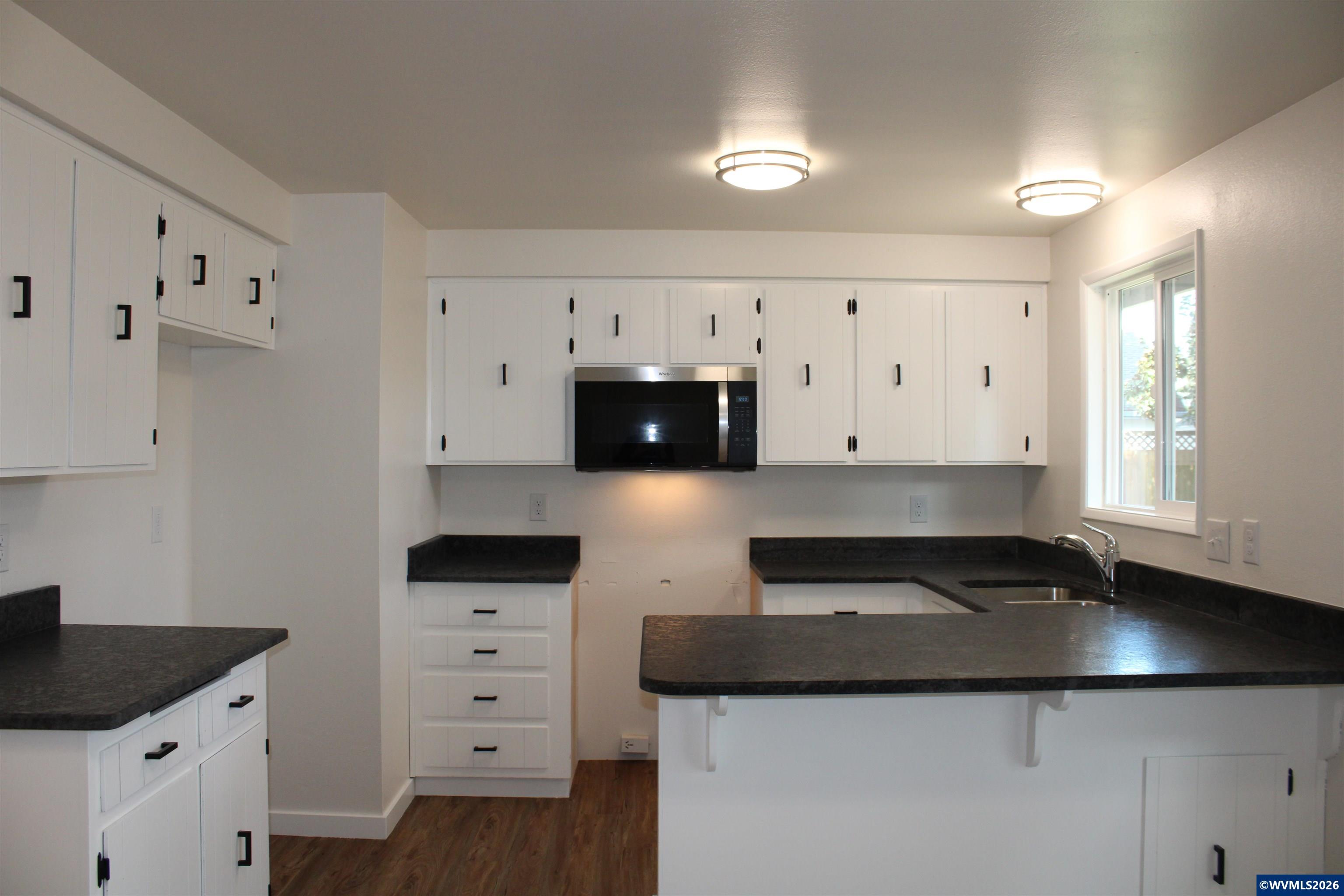 6259 Chapman Place Southwest Albany, OR 97321 - Photo 6 of 21 a kitchen with granite countertop a cabinets and a stove top oven