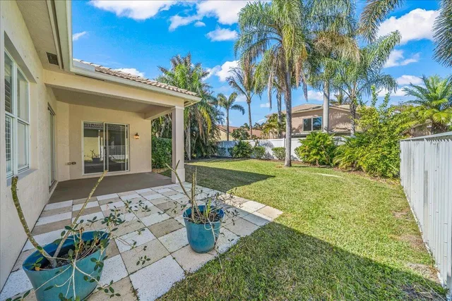 a view of backyard of house with green space