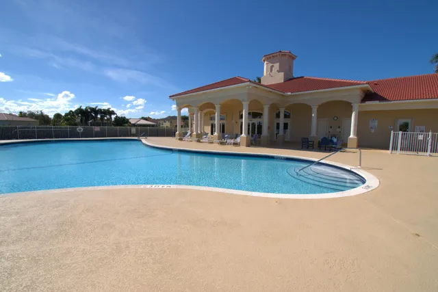 a view of swimming pool with a table and chairs