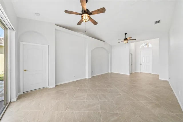 a view of empty room with ceiling fan