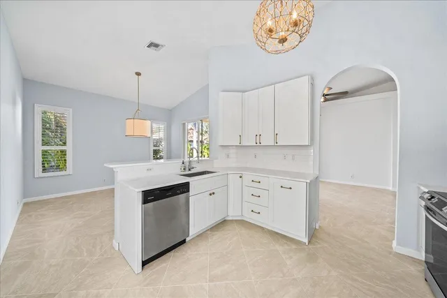 a kitchen with cabinets stainless steel appliances and a counter space