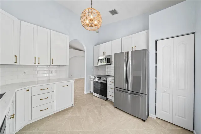 a kitchen with a sink stove and cabinets