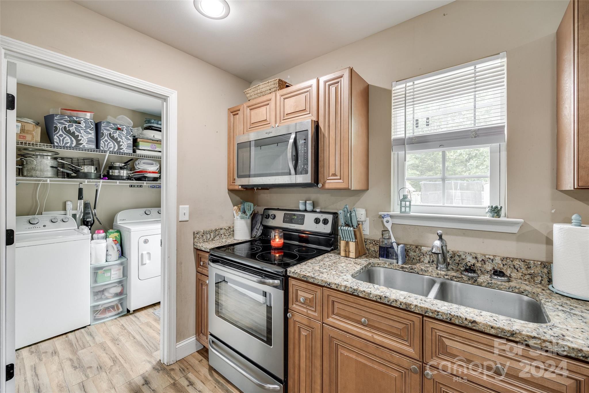 199 Cheek Road Clover, SC 29710 - Photo 11 of 27 a kitchen with granite countertop a sink a window stainless steel appliances and cabinets