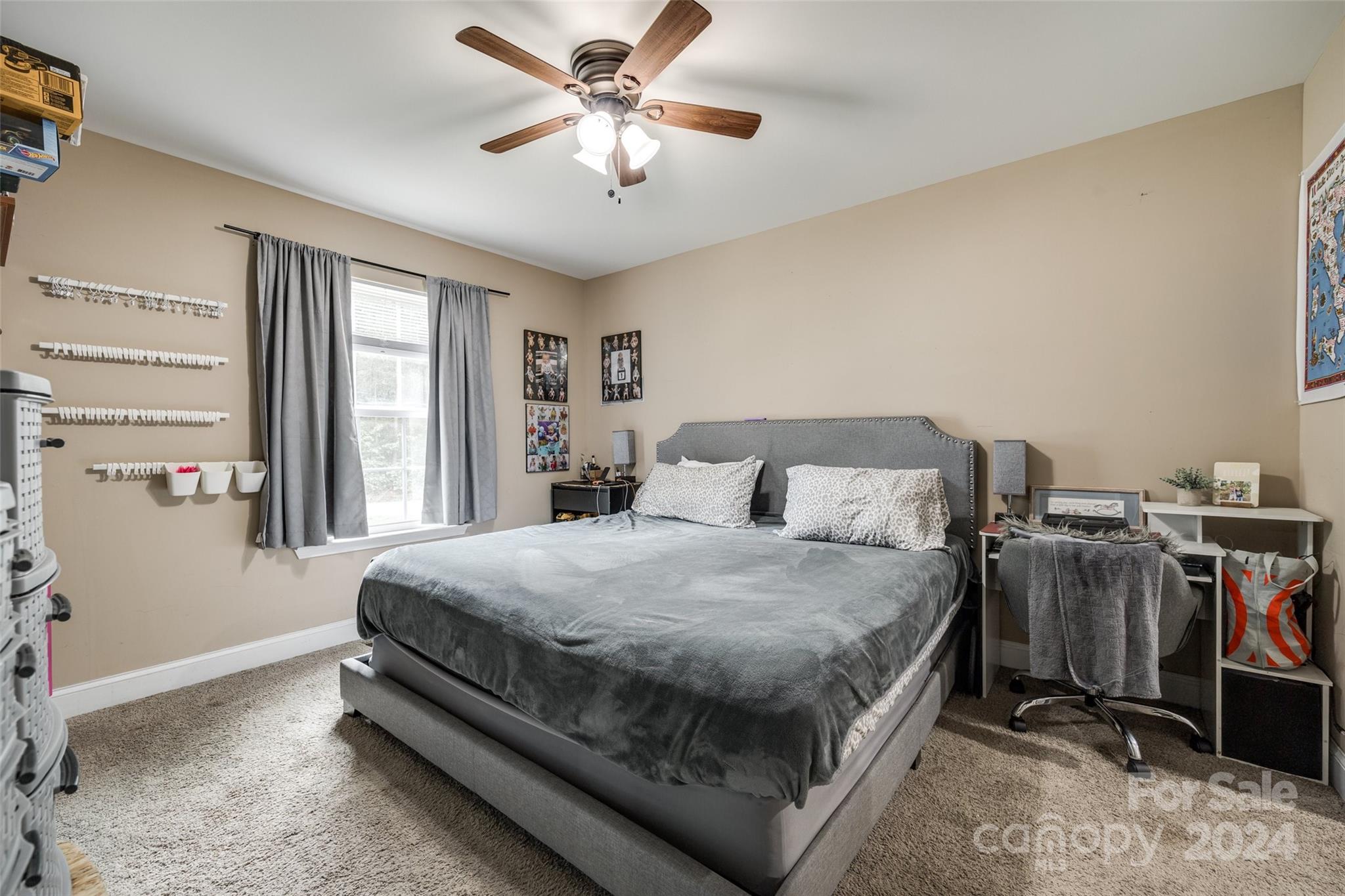 199 Cheek Road Clover, SC 29710 - Photo 14 of 27 a bedroom with a bed a window and a chandelier