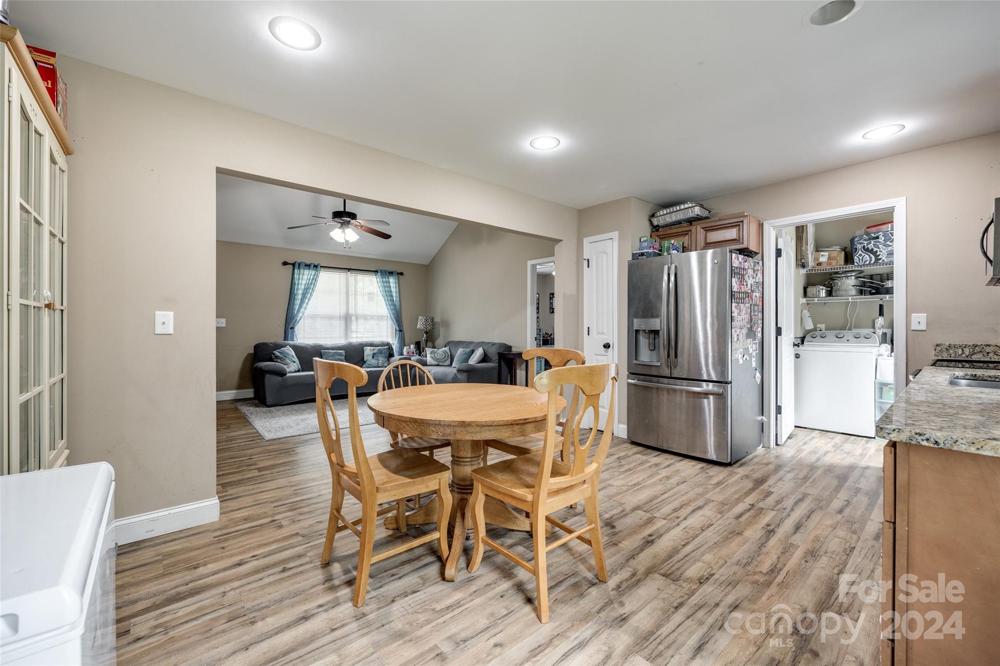 199 Cheek Road Clover, SC 29710 - Photo 9 of 27 a kitchen with stainless steel appliances a refrigerator a stove a dining table and chairs